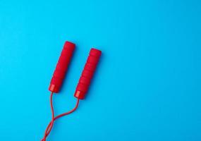 fragment of red rope for sports on a blue background photo