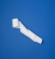 twisted white ribbon for cash register on a blue background photo