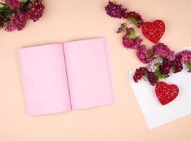 open notebook with pink blank pages photo