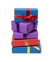 stack of boxes wrapped in paper and tied with a silk ribbon on a white background, celebration. Gift boxes set photo