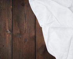 white linen towel on wooden background, top view photo