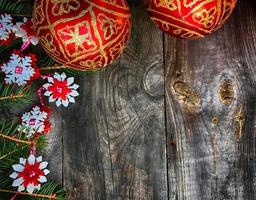 Christmas background with decorated branches of spruce and red glass balls photo