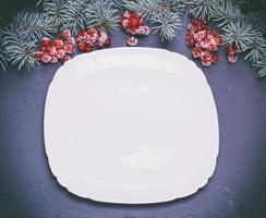 an empty white square plate on a black background photo