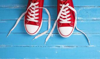 pair of red  sneakers with white laces photo