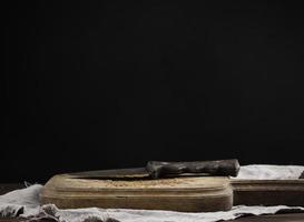 Empty wooden cutting board on black table, food display template photo