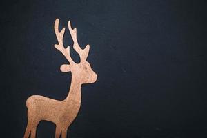 wooden carved deer on a black background photo