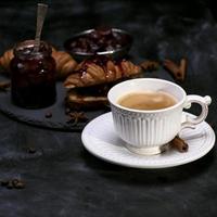 white cup with black coffee photo