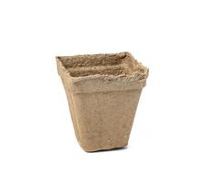 recyclable cardboard cup for planting seedlings and seeds isolated on white background. Ecological items, zero waste photo