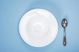 empty plate for soup and iron vintage spoon photo