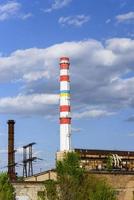 white pipe factory against a blue sky photo