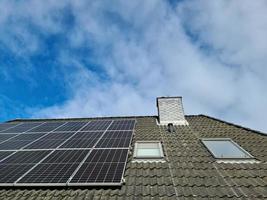 Solar panels producing clean energy on a roof of a residential house in Germany photo