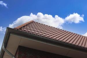 Open roof window in velux style with black roof tiles. photo