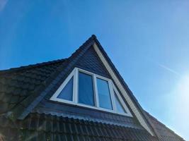 window in velux style with black roof tiles with some lens flares and glows photo