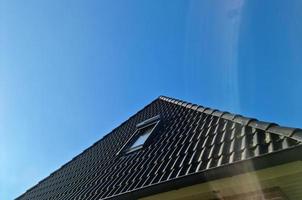 ventana en estilo velux con tejas negras con algunas bengalas y brillos foto