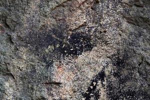 Close up view at a granite and stone wall texture in a high resolution. photo