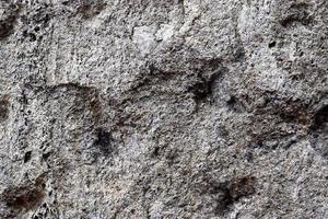 Close up view at a granite and stone wall texture in a high resolution. photo