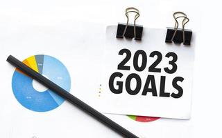 goals 2023 on notebook with charts and pencil photo