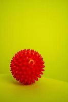 Red spike ball on yellow background photo