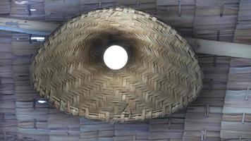 Round lamp with woven bamboo as a lantern. under a roof made of bamboo. photo