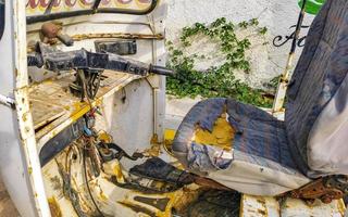 Old white broken wrecked tuk tuk rikshaw wreck in Mexico. photo