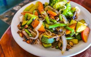 Fried rice and vegetables on white plate Puerto Escondido Mexico. photo