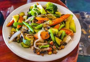 Fried rice and vegetables on white plate Puerto Escondido Mexico. photo