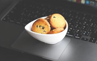 internet cookies, mini cookies on keyboard computer laptop for internet browser cookies concept photo