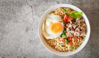 noodles bowl with boiled egg minced pork vegetable spring onion lemon on table food , instant noodles cooking tasty eating with bowl noodle soup - top view photo