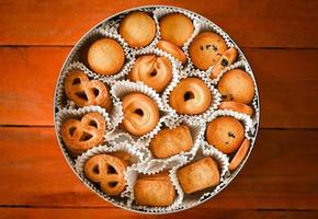 cookie box with danish butter cookies on wooden table background photo