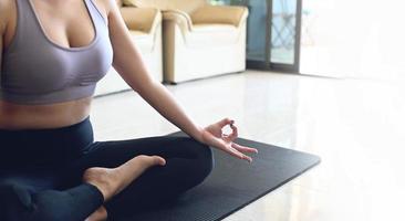yoga woman in home, yoga pose lesson breathing meditation exercise working out wearing sportswear, women doing exercising at home indoor well being wellness young girl people do practicing yoga indoor photo