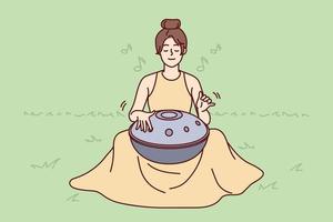 Young woman sit on grass outdoors play on traditional musical instrument meditating. Female yogi use harmony handpan or drum for meditation. Spiritual. Vector illustration.