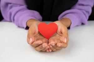 female holding love shape paper for valentines and romance symbol photo