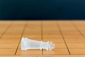 Chess glass on a wood chessboard photo