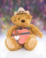 Teddy bear with red heart shaped gift box photo