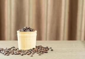 Coffee beans in wood bucket photo