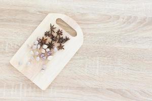 Top view Star anise and garlic on wood chopping board photo