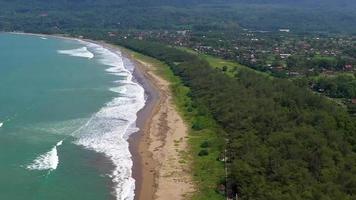 Aerial view of a blue beach with beautiful waves and big rocks video