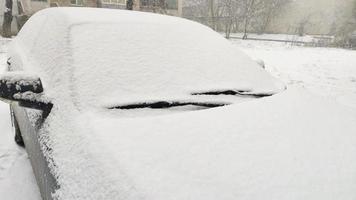 Car covered with snow on parking video