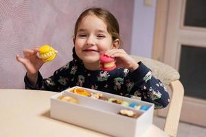 Girl choose what to eat delicious tasty sweet color macaron. photo