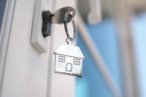 Home key for unlocking the new house door. Renting, buying, selling houses photo