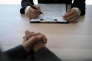 Executives are interviewing candidates. Focusing on resume writing tips, applicant qualifications, interview skills and pre-interview preparation. Considerations for new employees photo