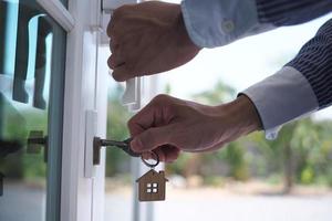 Landlord unlocks the house key for new home photo