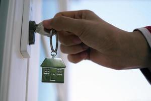 Landlord unlocks the house key for new home photo