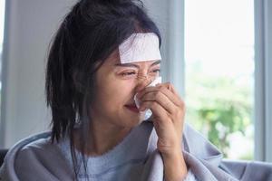 Asian women have high fever and runny nose. sick people concept photo