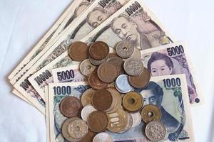 Japanese yen notes and Japanese yen coins for money concept background photo