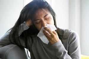 Asian women have high fever and runny nose. sick people concept photo