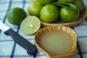 Fresh lime juice made in the glass photo