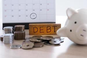 Due for repayment There are coins, calculators and calendar reminders placed on the table. photo