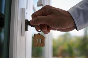 Landlord unlocks the house key for new home photo