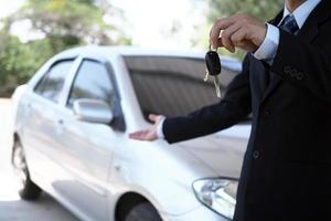 Car salesmen and keys presenting car trading photo